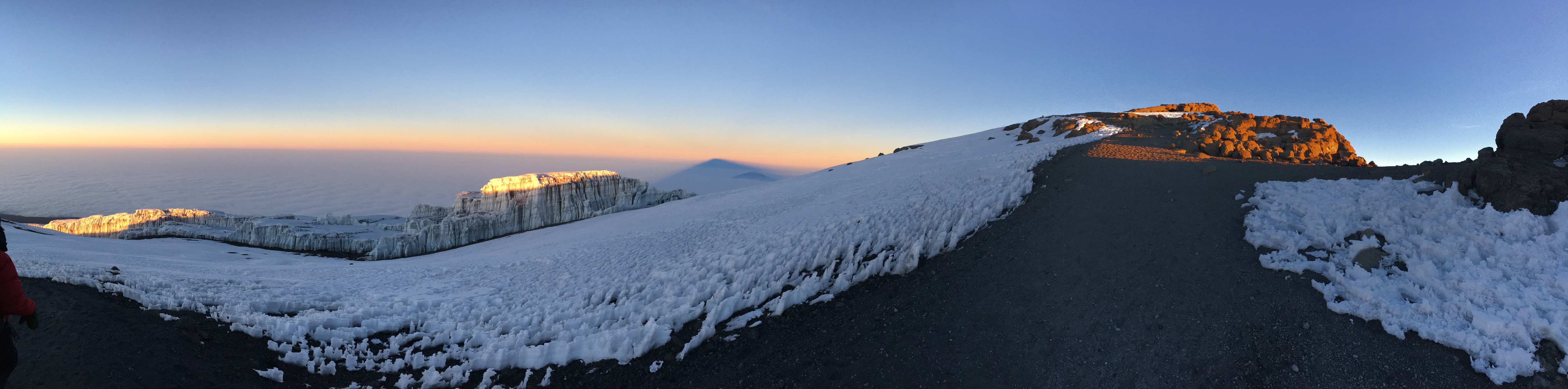 A photograph of the sun rising near the summit of Mount Kilimanjaro